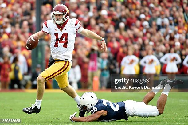 Quarterback Sam Darnold of the USC Trojans runs with the ball as cornerback John Reid of the Penn State Nittany Lions attempts to tackle him in the...