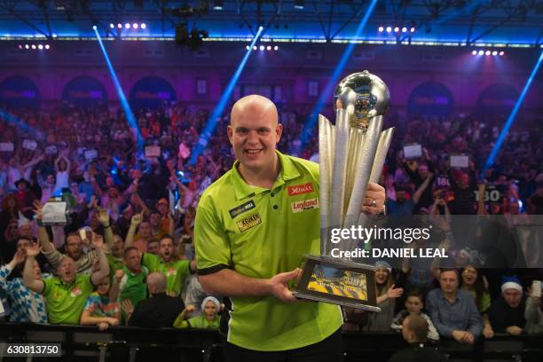 Netherlands' Michael van Gerwen poses for a photograph with the Sid Waddell trophy after his victory in the PDC World Championship darts final over...