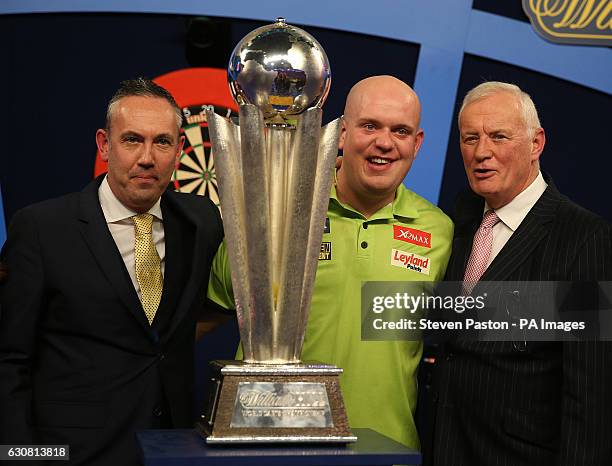 Simon Kew, Head of trading for William Hill Online , Michael van Gerwen and Barry Hearn chairman of the PDC with the Sid Waddell trophy during day...