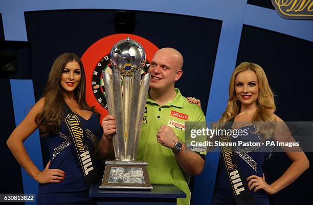 Michael van Gerwen celebrates with the Sid Waddell trophy during day fifteen of the William Hill World Darts Championship at Alexandra Palace, London.