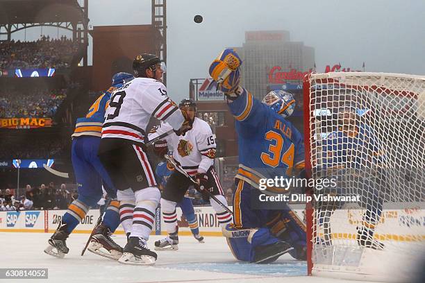 Jake Allen of the St. Louis Blues makes a save against Jonathan Toews of the Chicago Blackhawks during the 2017 Bridgestone NHL Winter Classic at...