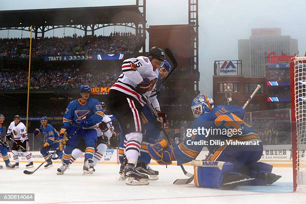 Jake Allen of the St. Louis Blues makes a save against Artem Anisimov of the Chicago Blackhawks during the 2017 Bridgestone NHL Winter Classic at...