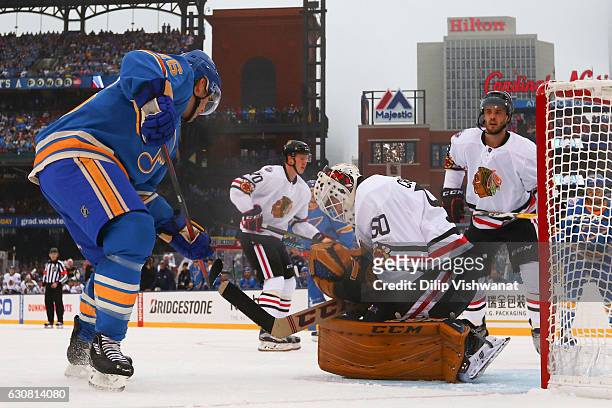Corey Crawford of the Chicago Blackhawks makes a save against Paul Stastny of the St. Louis Blues during the 2017 Bridgestone NHL Winter Classic at...