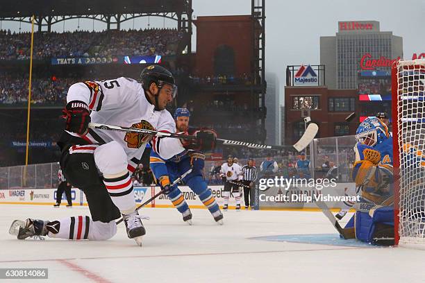 Artem Anisimov of the Chicago Blackhawks takes a shot against Jake Allen of the St. Louis Blues during the 2017 Bridgestone NHL Winter Classic at...