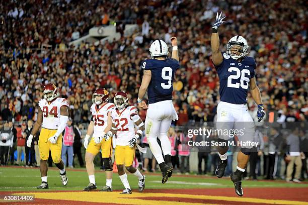 Quarterback Trace McSorley of the Penn State Nittany Lions celebrates with running back Saquon Barkley after rushing for a 3-yard touchdown in the...