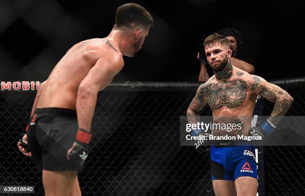 Cody Garbrandt and Dominick Cruz taunt each other in their UFC bantamweight championship bout during the UFC 207 event at T-Mobile Arena on December...