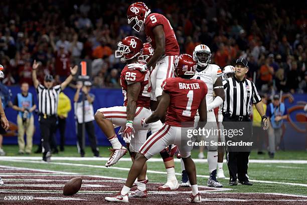 Joe Mixon of the Oklahoma Sooners reacts after scoring a touchdown against the Auburn Tigers during the Allstate Sugar Bowl at the Mercedes-Benz...