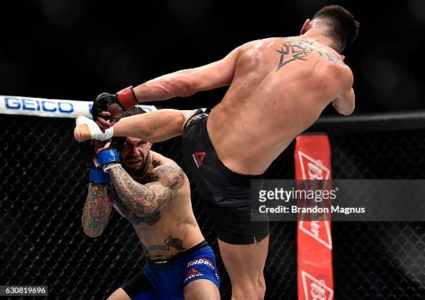 Dominick Cruz kicks Cody Garbrandt in their UFC bantamweight championship bout during the UFC 207 event at T-Mobile Arena on December 30, 2016 in Las...