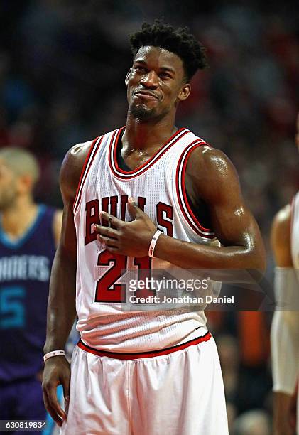Jimmy Butler of the Chicago Bulls smiles before shooting a free-throw for his 50th point of the game against the Charlotte Hornets at the United...