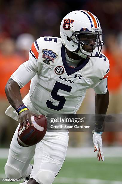 John Franklin III of the Auburn Tigers scrambles with the ball against the Oklahoma Sooners during the Allstate Sugar Bowl at the Mercedes-Benz...