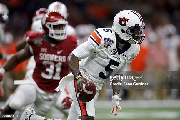 John Franklin III of the Auburn Tigers scrambles with the ball against the Oklahoma Sooners during the Allstate Sugar Bowl at the Mercedes-Benz...