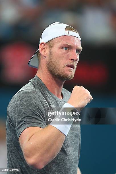 Sam Groth of Australia celebrates winning his match against Pierre-Hughes Herbert of France on day three of the 2017 Brisbane International at Pat...