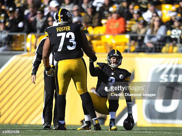 Quarterback Landry Jones of the Pittsburgh Steelers is helped off the field by left guard Ramon Foster after being sacked during a game against the...