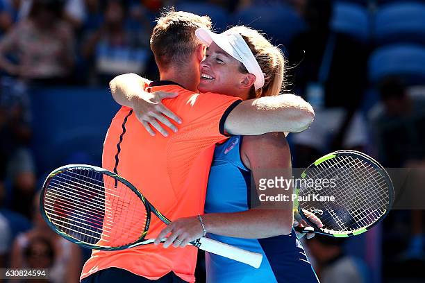 Jack Sock and Coco Vandeweghe of the United States embrace after winning the mixed doubles match against Lara Arruabarrena and Feliciano Lopez of...