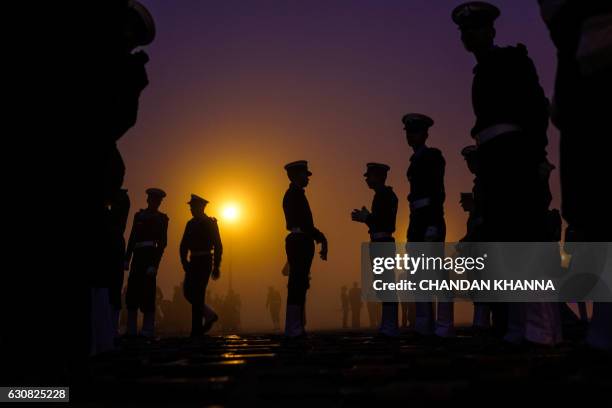 Indian military personnel prepare to march as they rehearse for the forthcoming Republic Day parade at Rajpath in New Delhi on January 3, 2017. India...