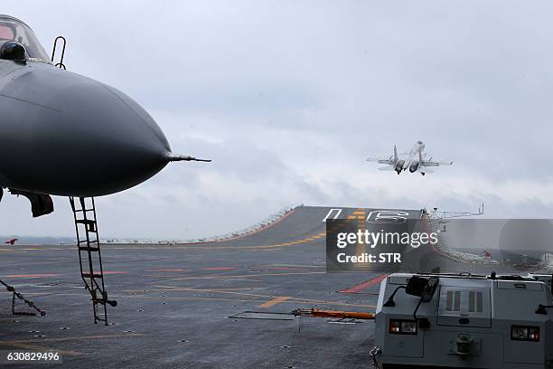 This photo taken on January 2, 2017 shows Chinese J-15 fighter jets being launched from the deck of the Liaoning aircraft carrier during military...