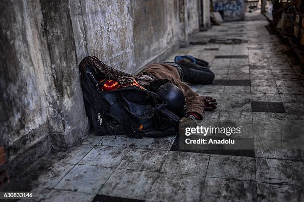 Man sleeps on a walkway outside entrance of one of the squatted apartments during a protest at the Borei Keila site in Phnom Penh, Cambodia on...