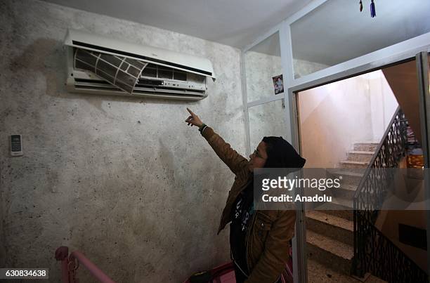 Kid points to a broken air conditioning after Israeli soldiers raid several houses at Balata Refugee Camp in Nablus, West Bank on January 3, 2017. No...