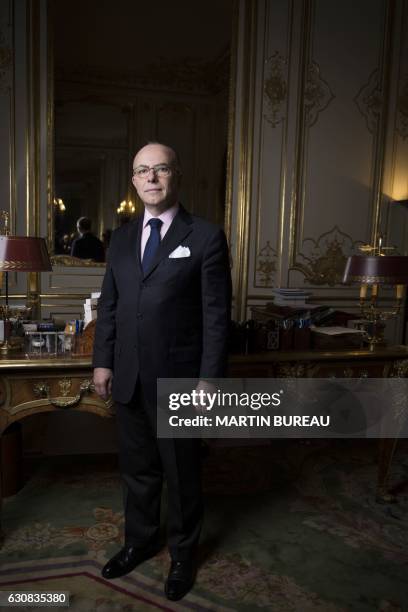 French Prime Minister Bernard Cazeneuve poses for a photo session in his office, on January 3, 2017 at the Matignon hotel in Paris.