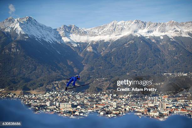 Vincent Descombes Sevoie of France soars through the air during his qualification jump on Day 1 of the 65th Four Hills Tournament ski jumping event...