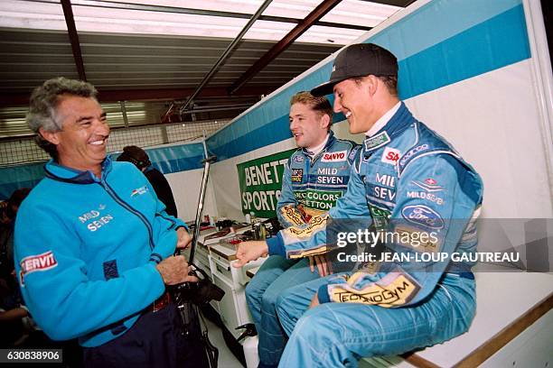 German driver Michael Schumacher talks with his Dutch team mate Jos Verstappen and Benetton-Ford team manager Flavio Briatore on August 26, 1994 in...