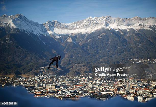 Piotr Zyla of Poland soars through the air during his qualification jump on Day 1 of the 65th Four Hills Tournament ski jumping event on January 3,...