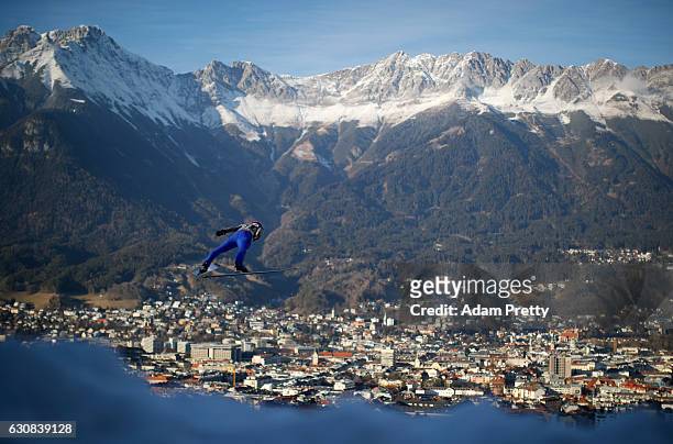 Manuel Fettner of Austria soars through the air during his qualification jump on Day 1 of the 65th Four Hills Tournament ski jumping event on January...