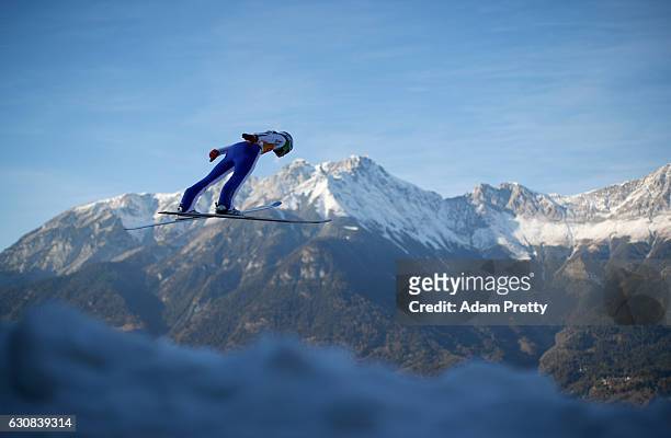Domen Prevc of Slovenia soars through the air during his qualification jump on Day 1 of the 65th Four Hills Tournament ski jumping event on January...