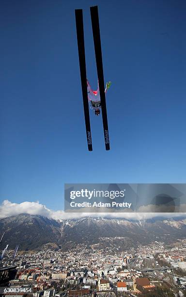 Mackenzie Boyd Clowes of Canada soars through the air during his qualification jump on Day 1 of the 65th Four Hills Tournament ski jumping event on...