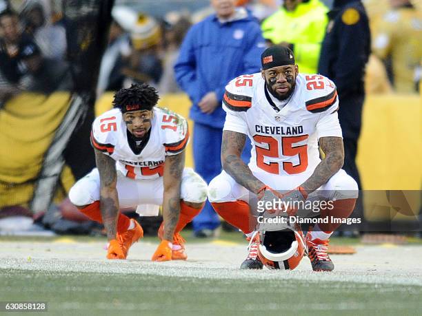 Running back George Atkinson III and wide receiver Mario Alford of the Cleveland Browns watch the action from the sideline during a game against the...