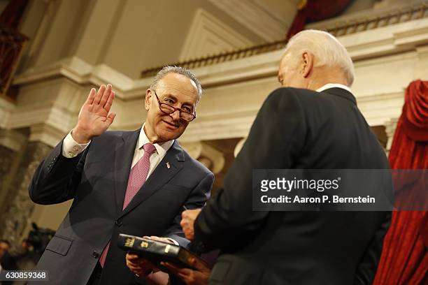 Sen. Chuck Schumer participates in a reenacted swearing-in with U.S. Vice President Joe Biden in the Old Senate Chamber at the U.S. Capitol January...