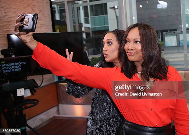 Actress Tia Mowry-Hardrict and actress/host Garcelle Beauvais pose for a selfie at Hollywood Today Live at W Hollywood on January 3, 2017 in...