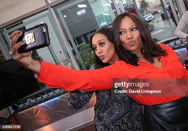 Actress Tia Mowry-Hardrict and actress/host Garcelle Beauvais pose for a selfie at Hollywood Today Live at W Hollywood on January 3, 2017 in...