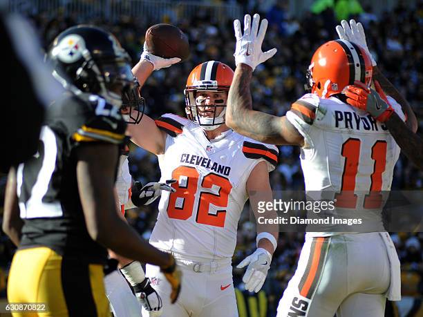 Tight end Gary Barnidge of the Cleveland Browns throws the ball to an official after catching a touchdown pass during a game against the Pittsburgh...