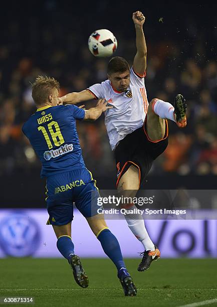 Guillherme Siqueira of Valencia competes for the ball with Daniel Wass of Celta Vigo during the Copa del Rey round of 16 first leg match between...