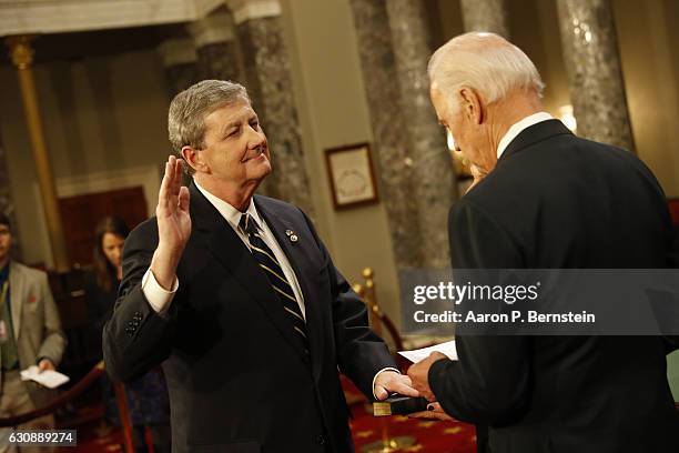 Sen. John Kennedy participates in a reenacted swearing-in with U.S. Vice President Joe Biden in the Old Senate Chamber at the U.S. Capitol January 3,...