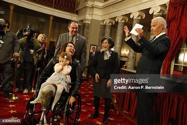 Sen. Tammy Duckworth participates in a reenacted swearing-in with U.S. Vice President Joe Biden in the Old Senate Chamber at the U.S. Capitol January...