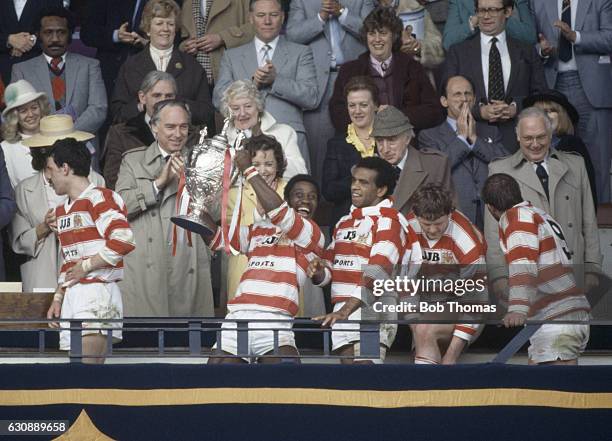 Henderson Gill of Wigan holds aloft the trophy following their victory in the Silk Cut Rugby League Challenge Cup final against Hull at Wembley...