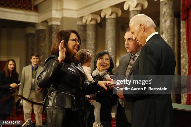 Sen. Tammy Duckworth participates in a reenacted swearing-in with U.S. Vice President Joe Biden in the Old Senate Chamber at the U.S. Capitol January...