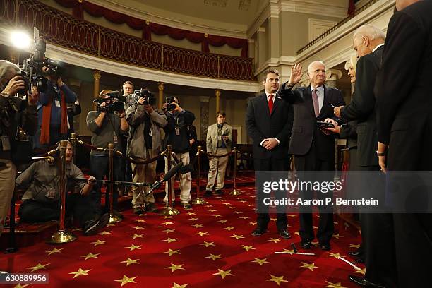 Sen. John McCain participates in a reenacted swearing-in with U.S. Vice President Joe Biden in the Old Senate Chamber at the U.S. Capitol January 3,...