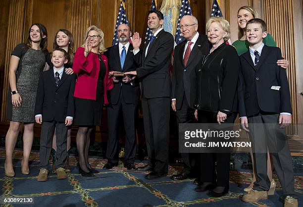 Former US Vice President Dick Cheney poses with US Congressman Paul Ryan , R-Wisconsin, as his daughter, US Congresswoman Liz Cheney is sworn in...