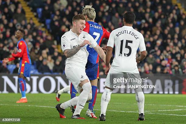 Swansea City's English defender Alfie Mawson celebrates with Swansea City's English midfielder Wayne Routledge after scoring the opening goal of the...