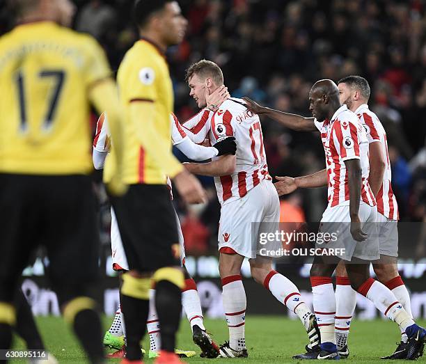 Stoke City's players congratulate their English defender Ryan Shawcross after he scores their opening goal in the English Premier League football...