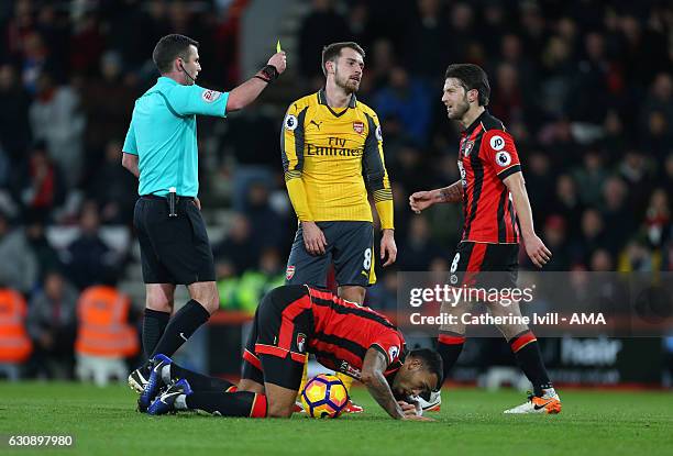 Referee Michael Oliver shows Aaron Ramsey of Arsenal a yellow card during the Premier League match between AFC Bournemouth and Arsenal at Vitality...