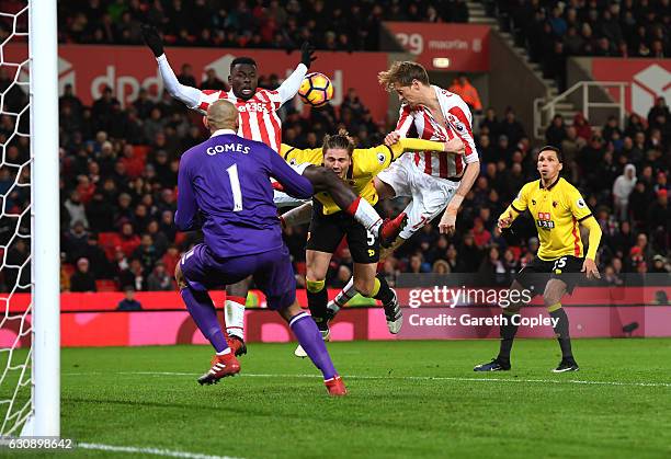 Peter Crouch of Stoke City and Sebastian Prodl of Watford compete for the ball during the Premier League match between Stoke City and Watford at...