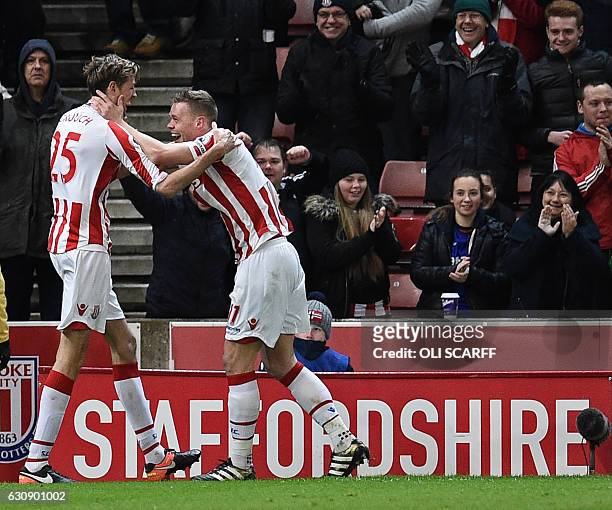 Stoke City's English striker Peter Crouch celebrates with Stoke City's English defender Ryan Shawcross after scoring their second goal during the...