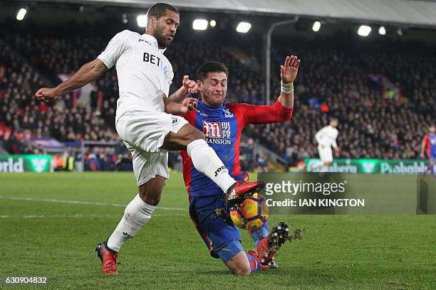 Crystal Palace's English defender Joel Ward vies with Swansea City's English midfielder Wayne Routledge during the English Premier League football...