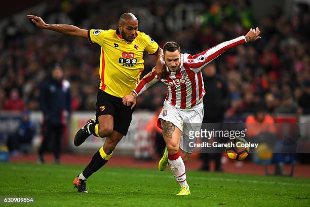 Marko Arnautovic of Stoke City and Younes Kaboul of Watford compete for the ball during the Premier League match between Stoke City and Watford at...
