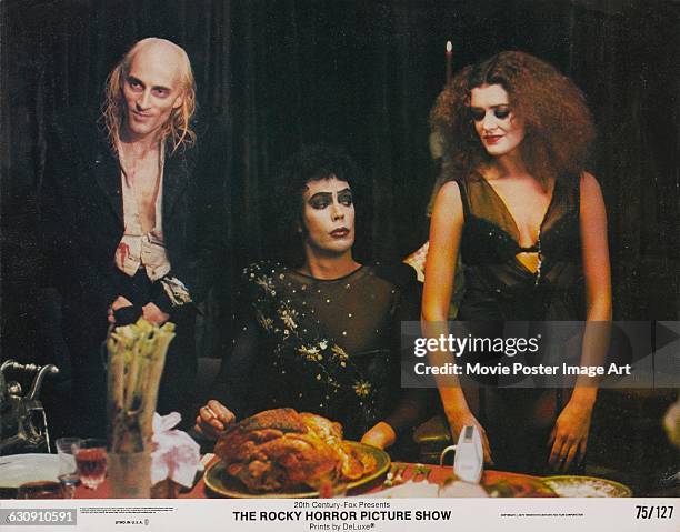 From left to right, actors Richard O'Brien, Tim Curry and Patricia Quinn as Riff Raff, Dr Frank-N-Furter and Magenta respectively, on a lobby card...