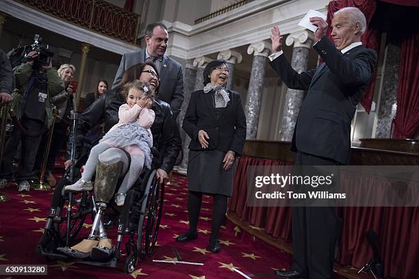 Vice President Joe Biden, right, talks with Sen. Tammy Duckworth, D-Ill., her mother Lamai, daughter Abigail and husband Bryan Bowlsbey, during...